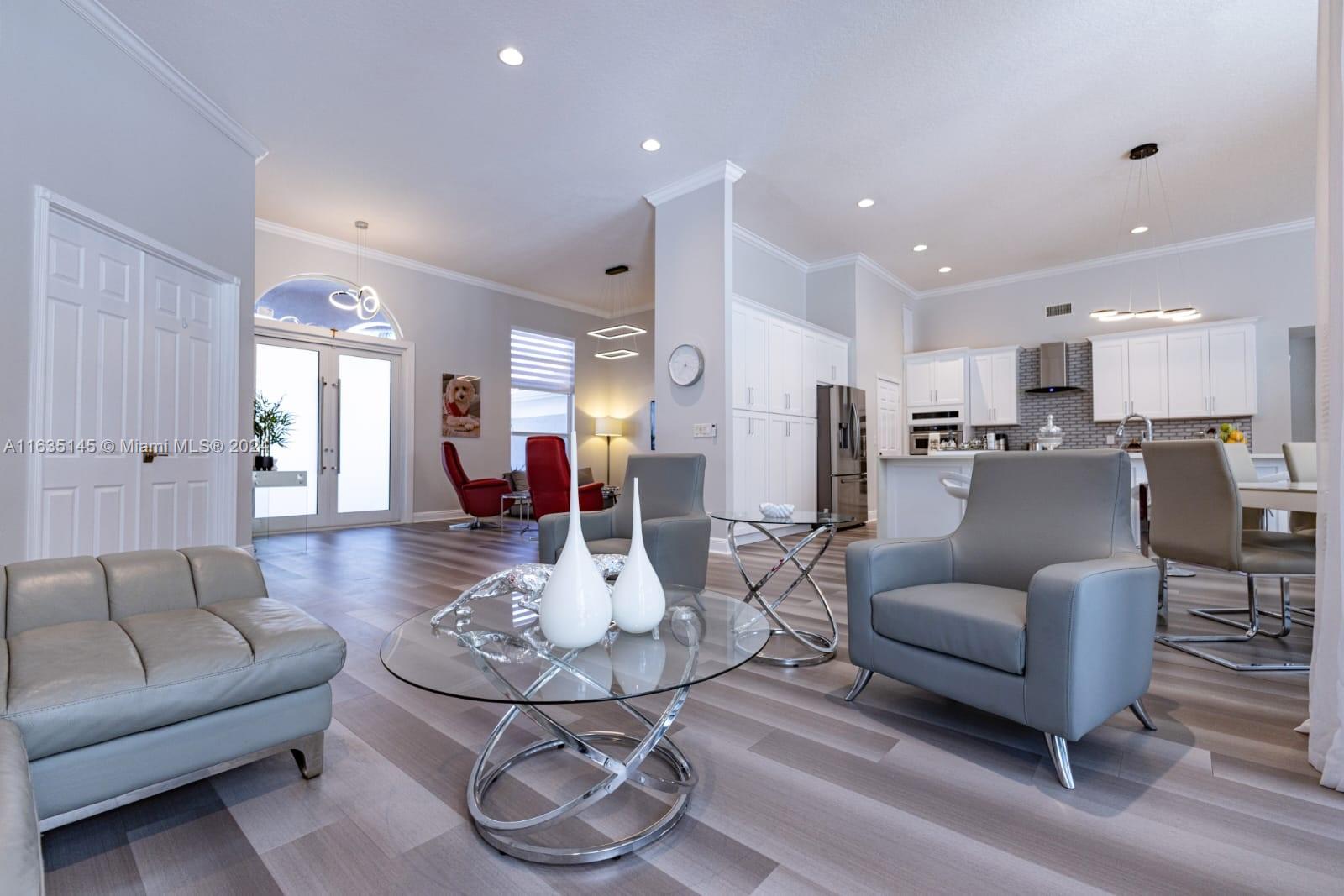 a living room with furniture kitchen view and a table