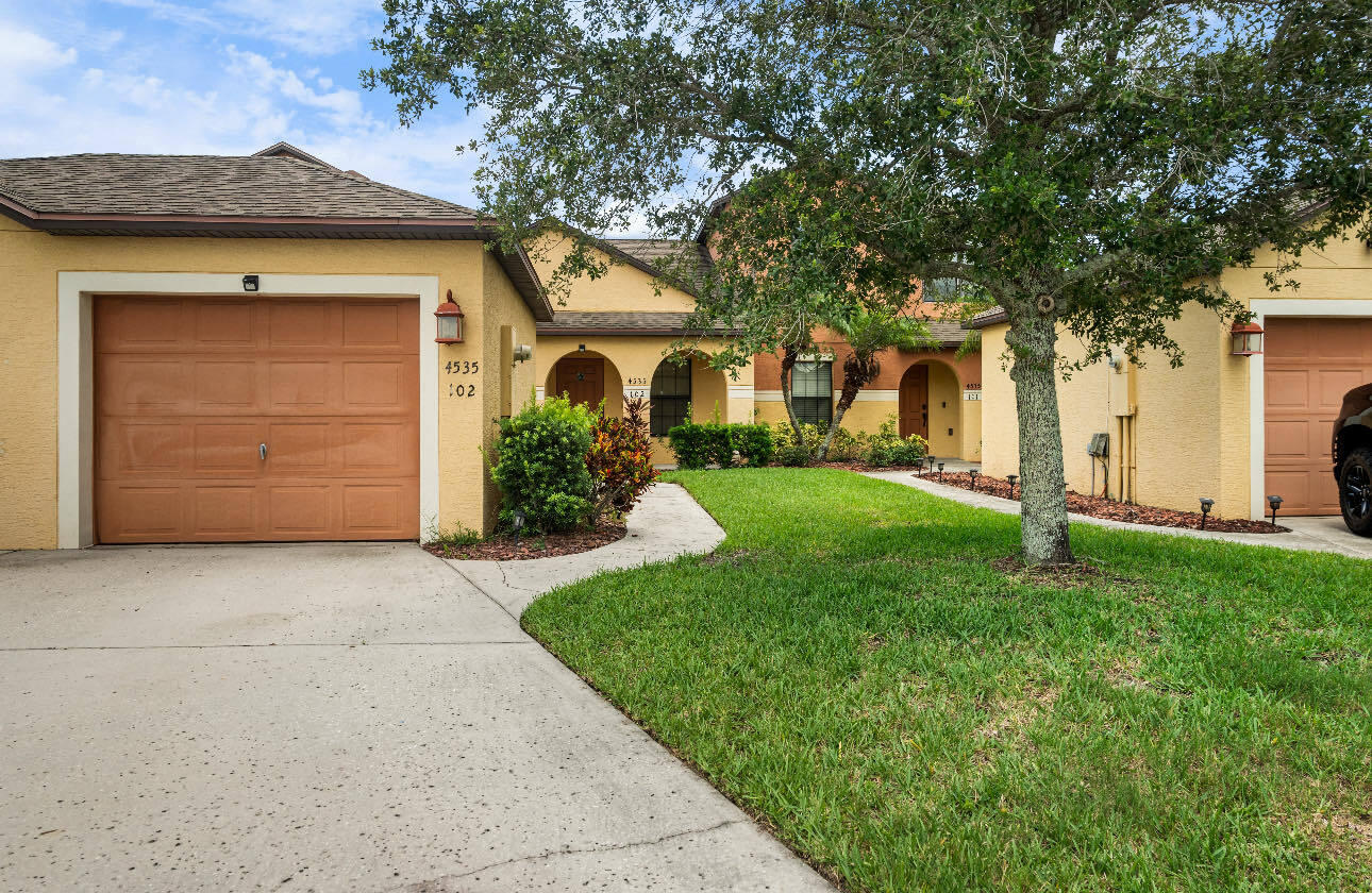 a front view of a house with a yard