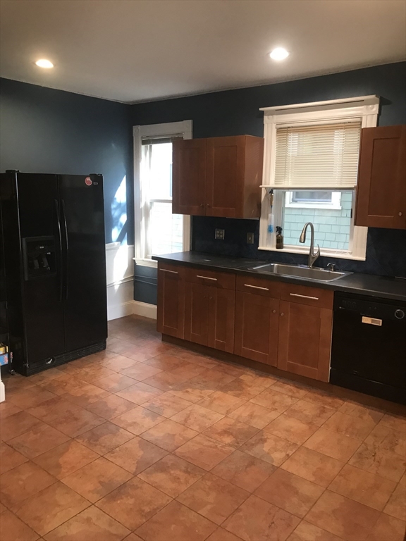 a kitchen with stainless steel appliances granite countertop a refrigerator and a sink