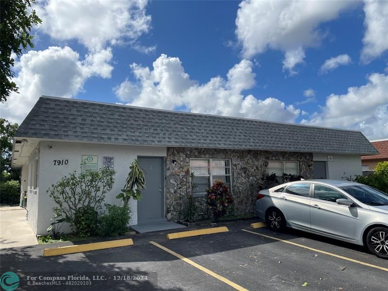 a view of a car parked in front of a house