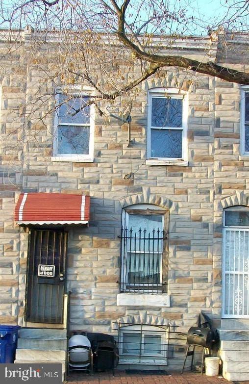 a brick building with a red door and a window