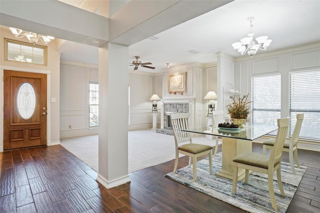 a living room with fireplace furniture and a wooden floor