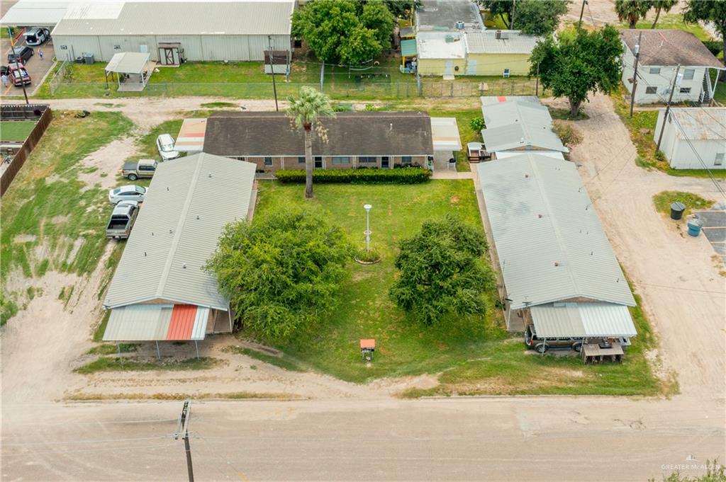 an aerial view of a house with a yard and lake view