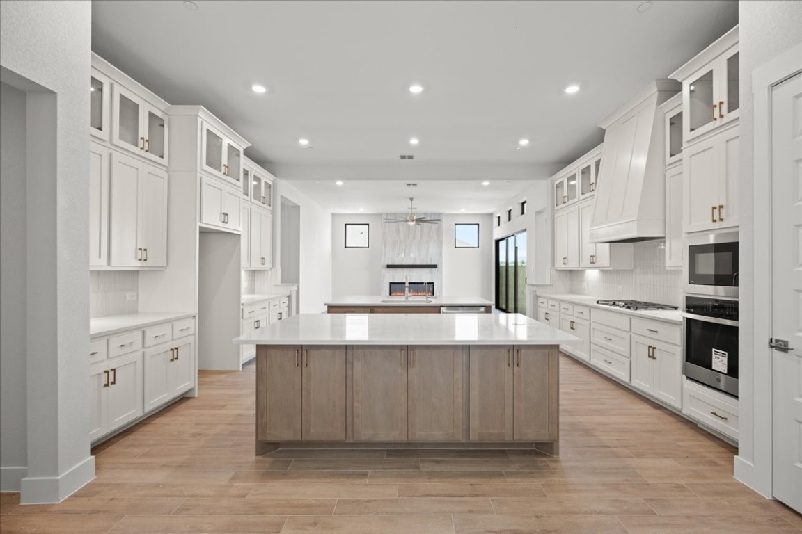 a large kitchen with stainless steel appliances lots of counter top space and cabinets