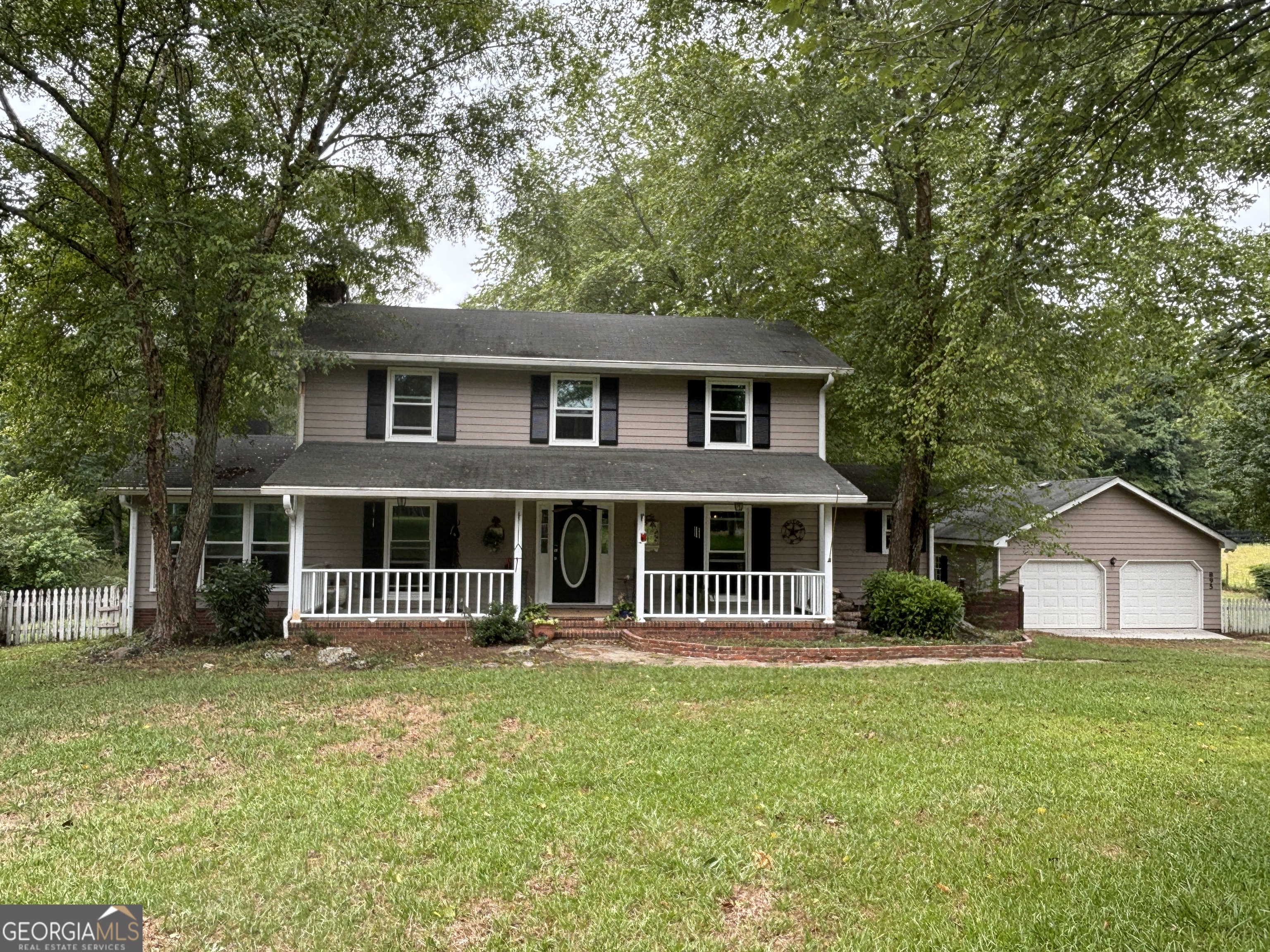 a front view of a house with a garden