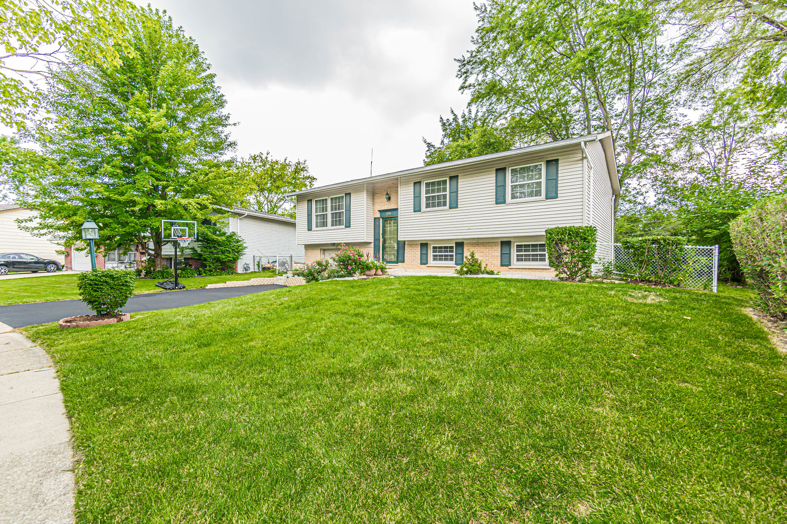 a front view of house with yard and green space