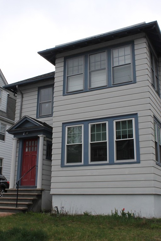 a front view of a house with a garden