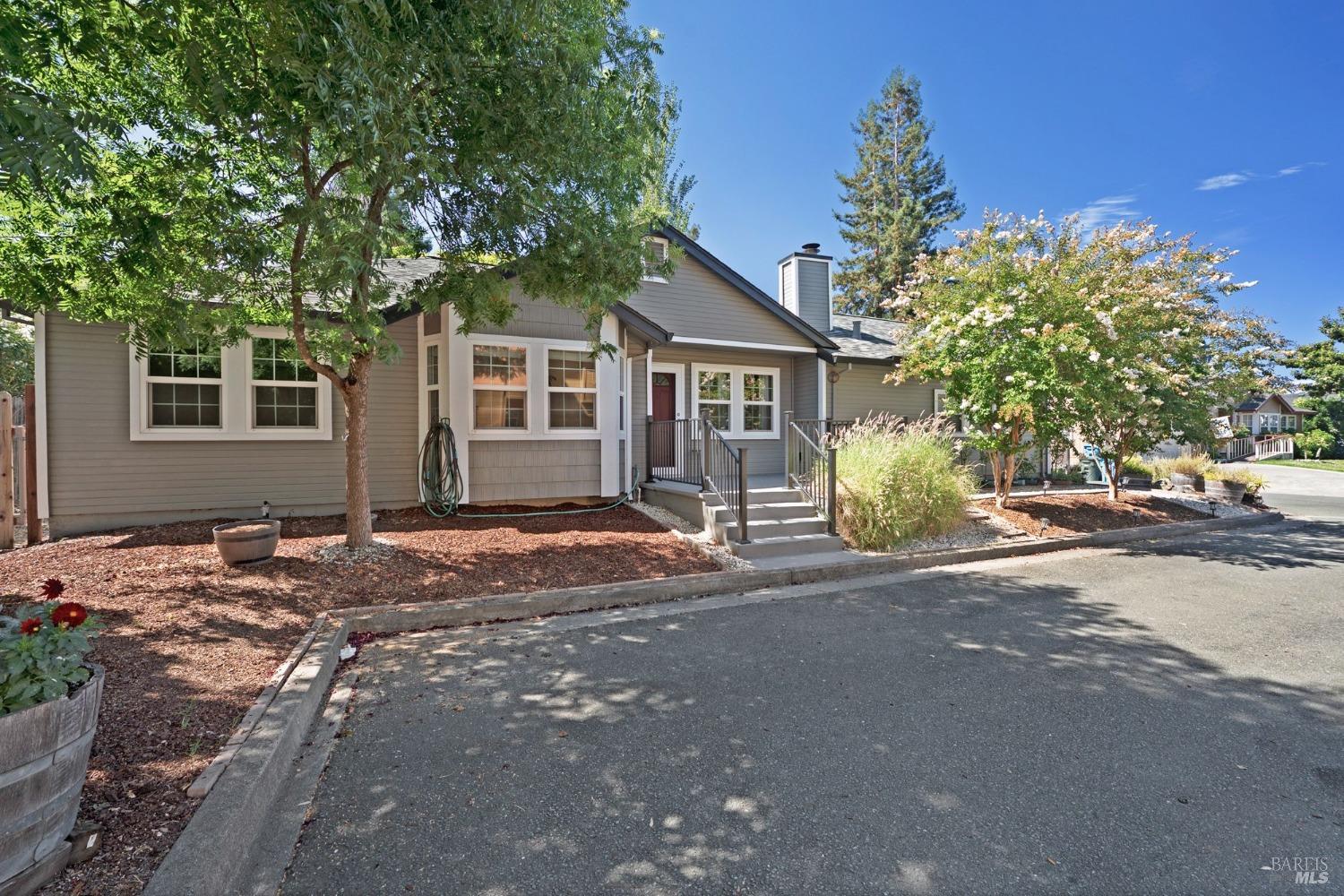 a front view of a house with a garden