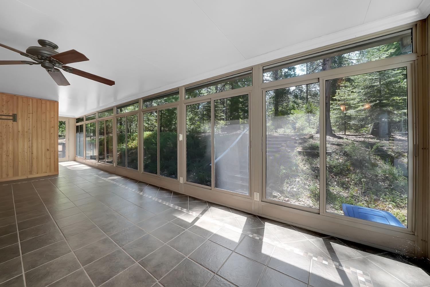 a view of empty room with floor to ceiling windows