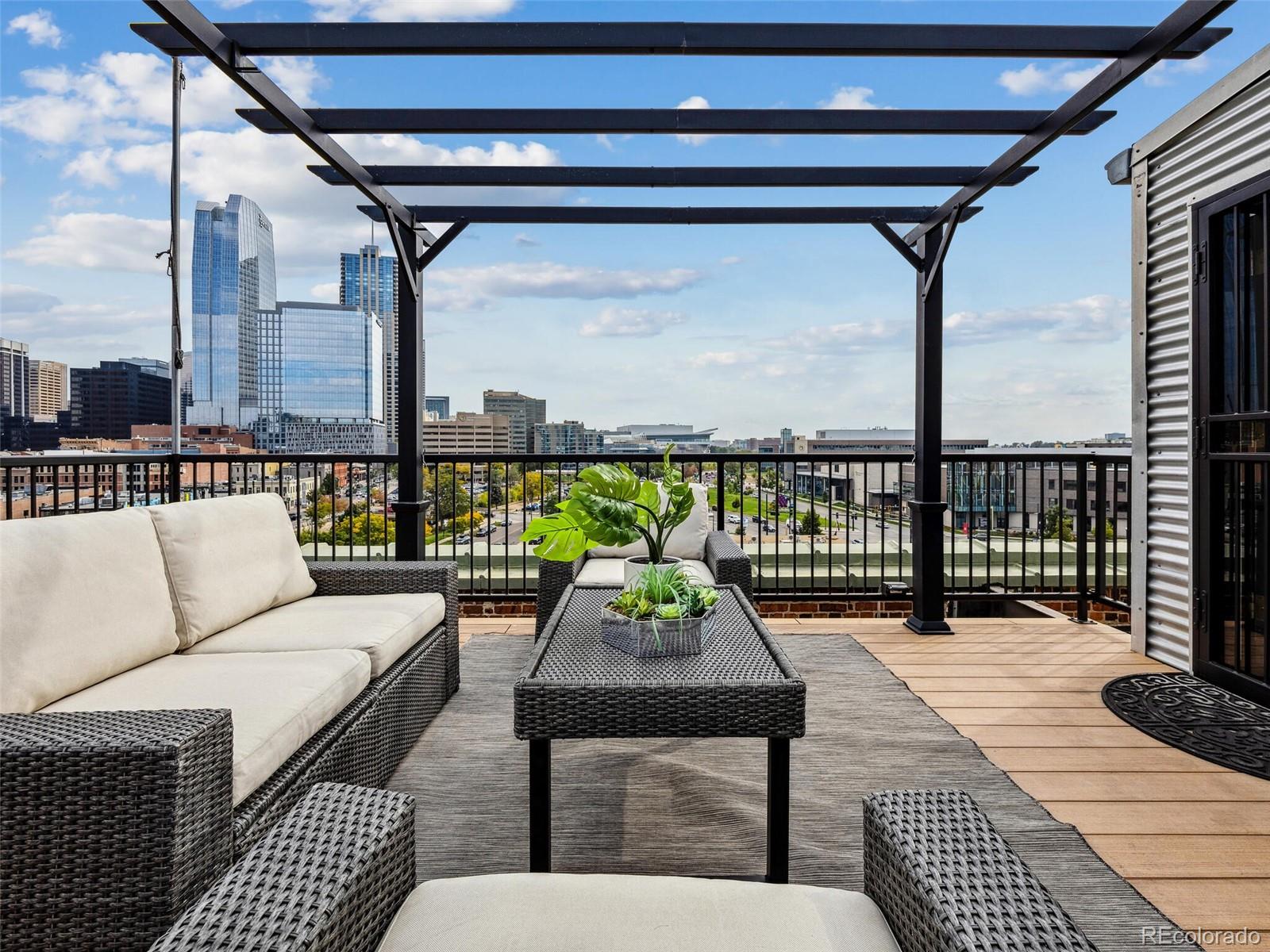 a balcony with furniture and wooden floor