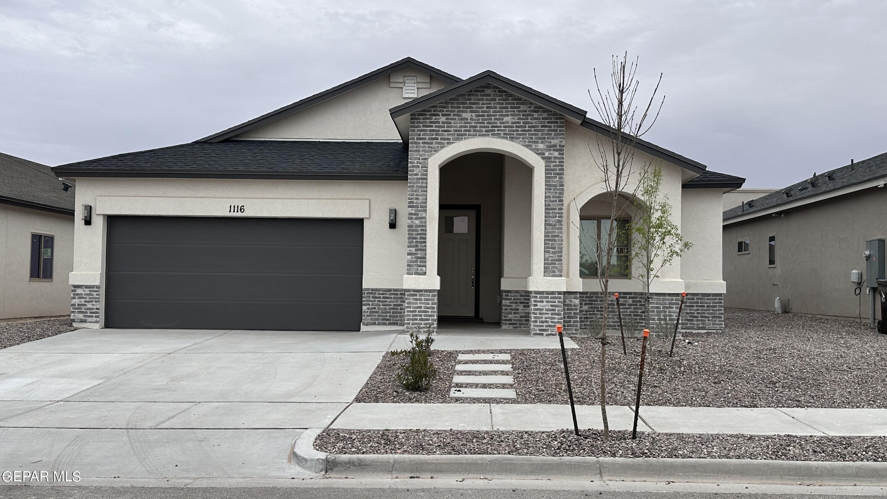 a front view of a house with garden