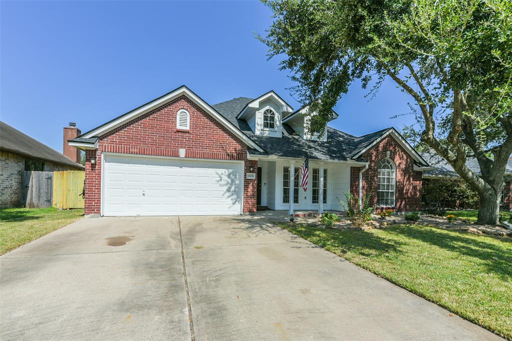 Charming single-story brick home with a two-car garage and a mature tree in the front yard, offering plenty of curb appeal in a pleasant neighborhood.