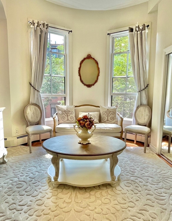 a view of a dining room with furniture wooden floor and a rug