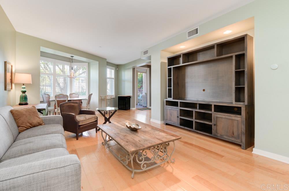 a living room with furniture a flat screen tv and a large window