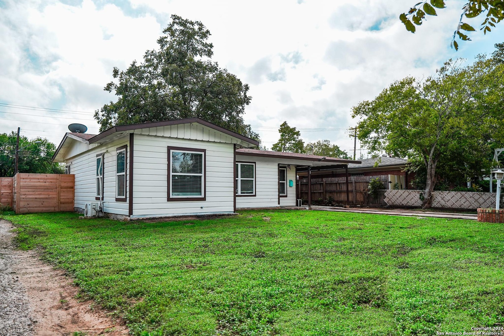 a view of a house with a yard and deck