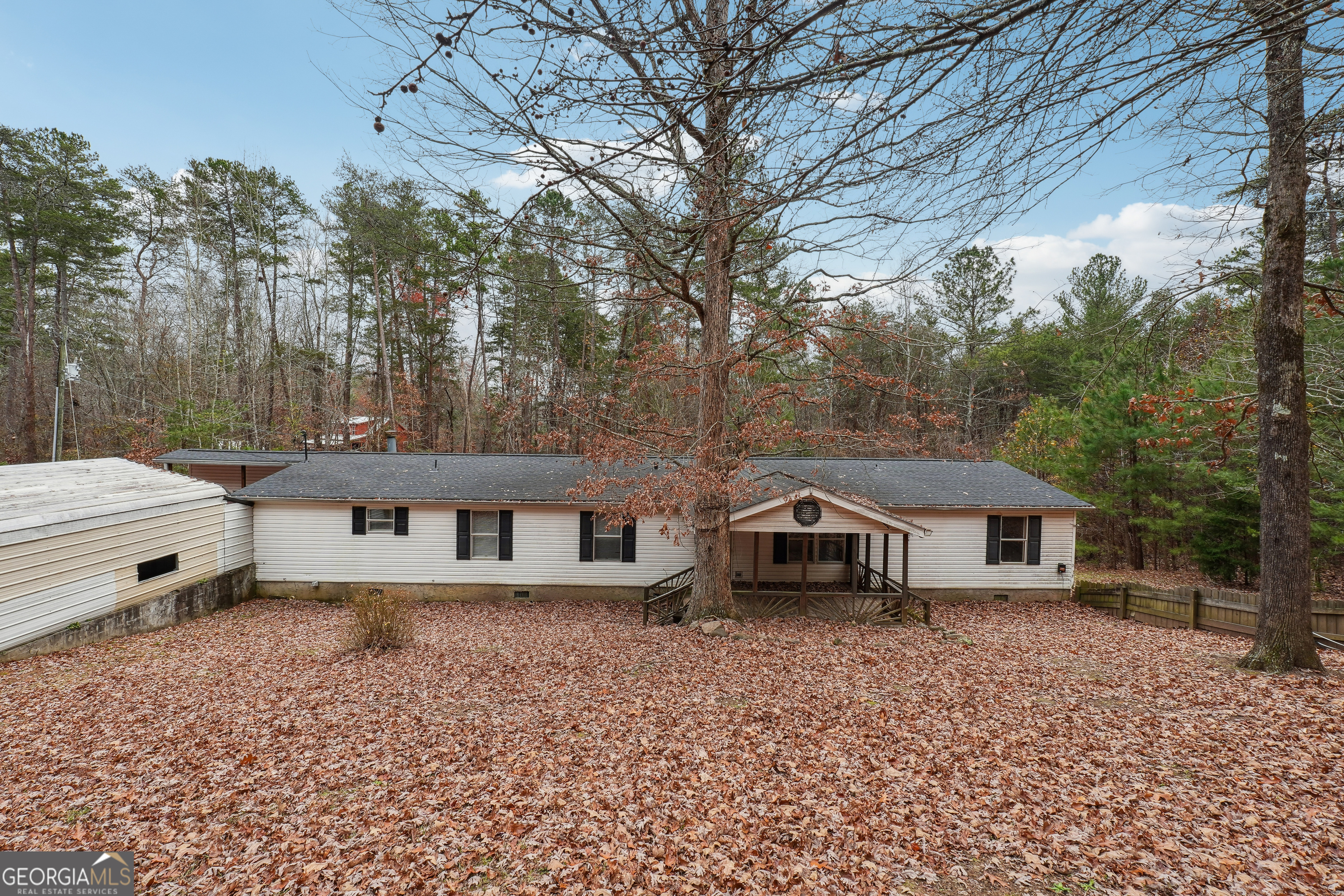 a view of house with outdoor space and sitting area