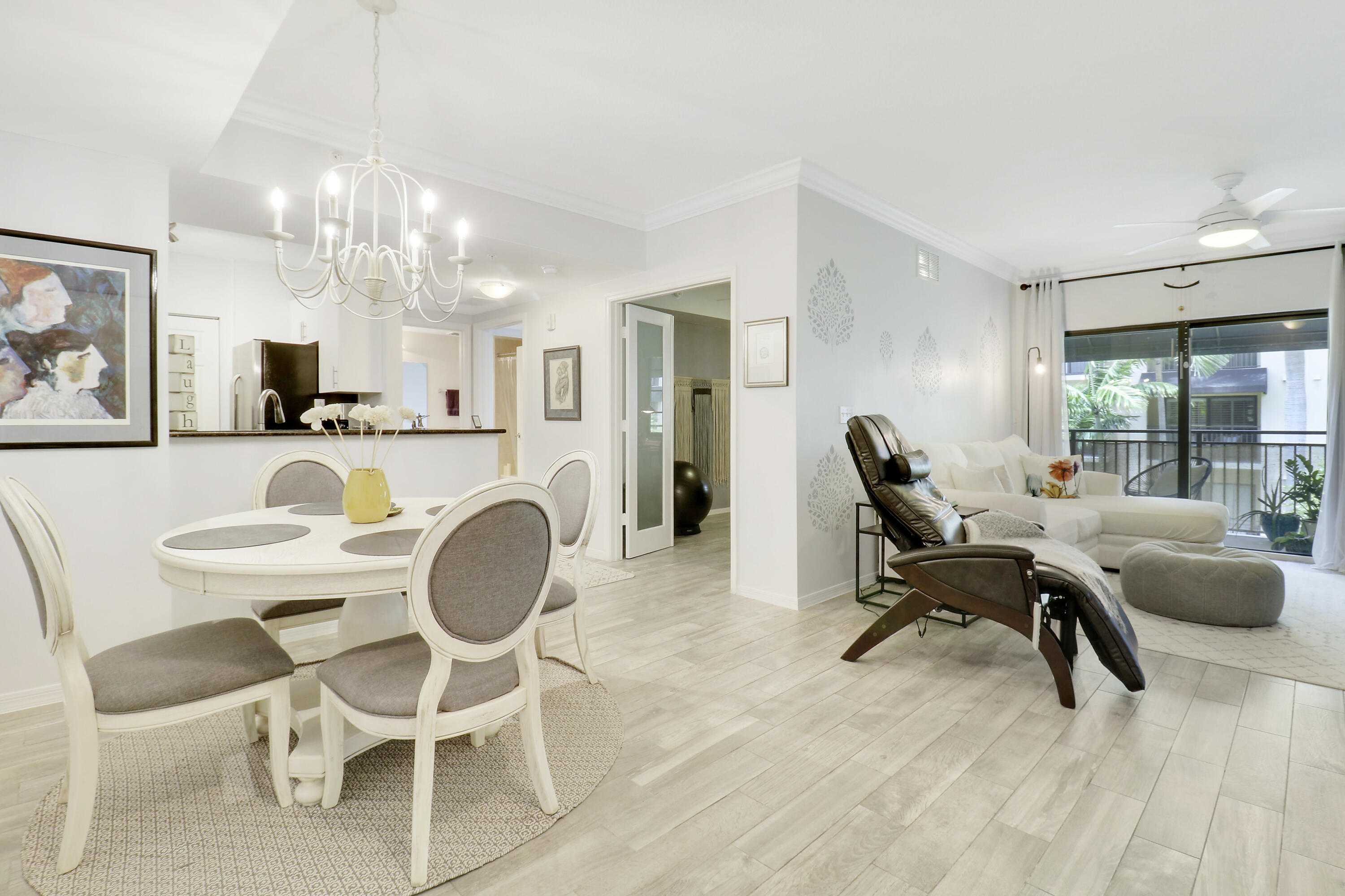 a living room with furniture a dining table and a chandelier