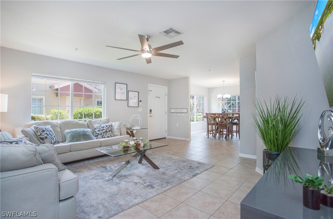 a living room with furniture and a potted plant