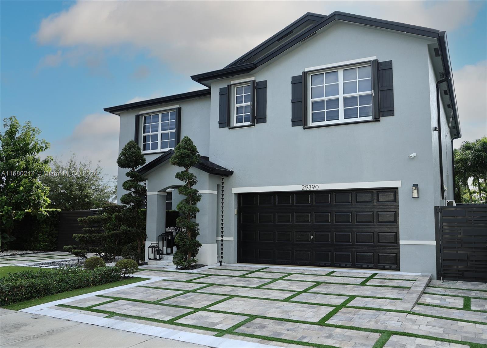 a front view of a house with garden