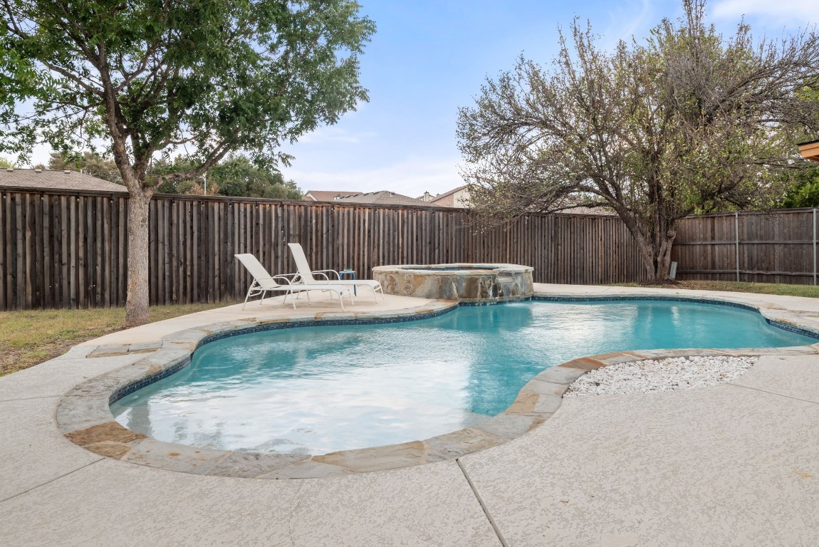 a backyard of a house with swimming pool and furniture