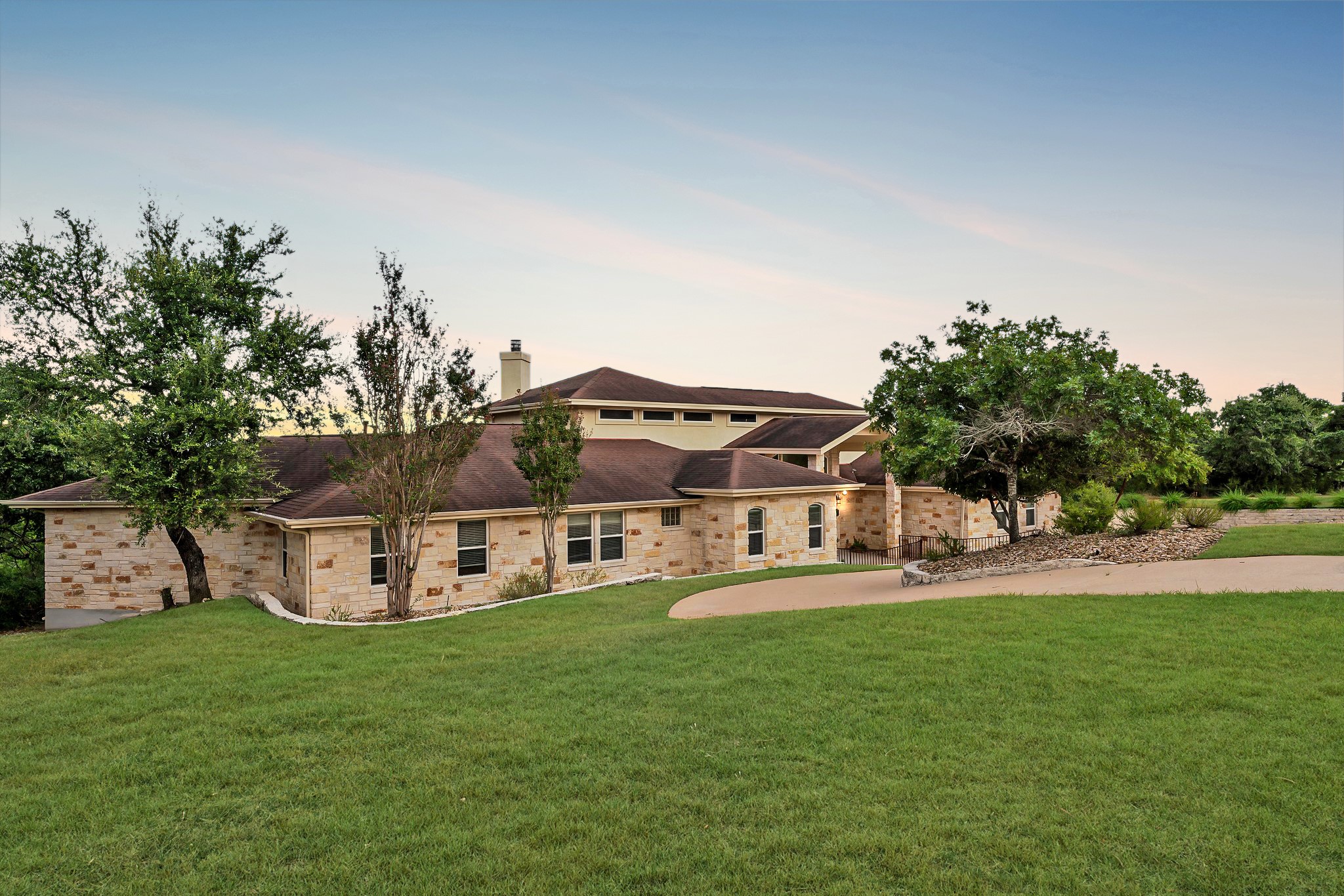 a view of a house with a big yard and sitting area