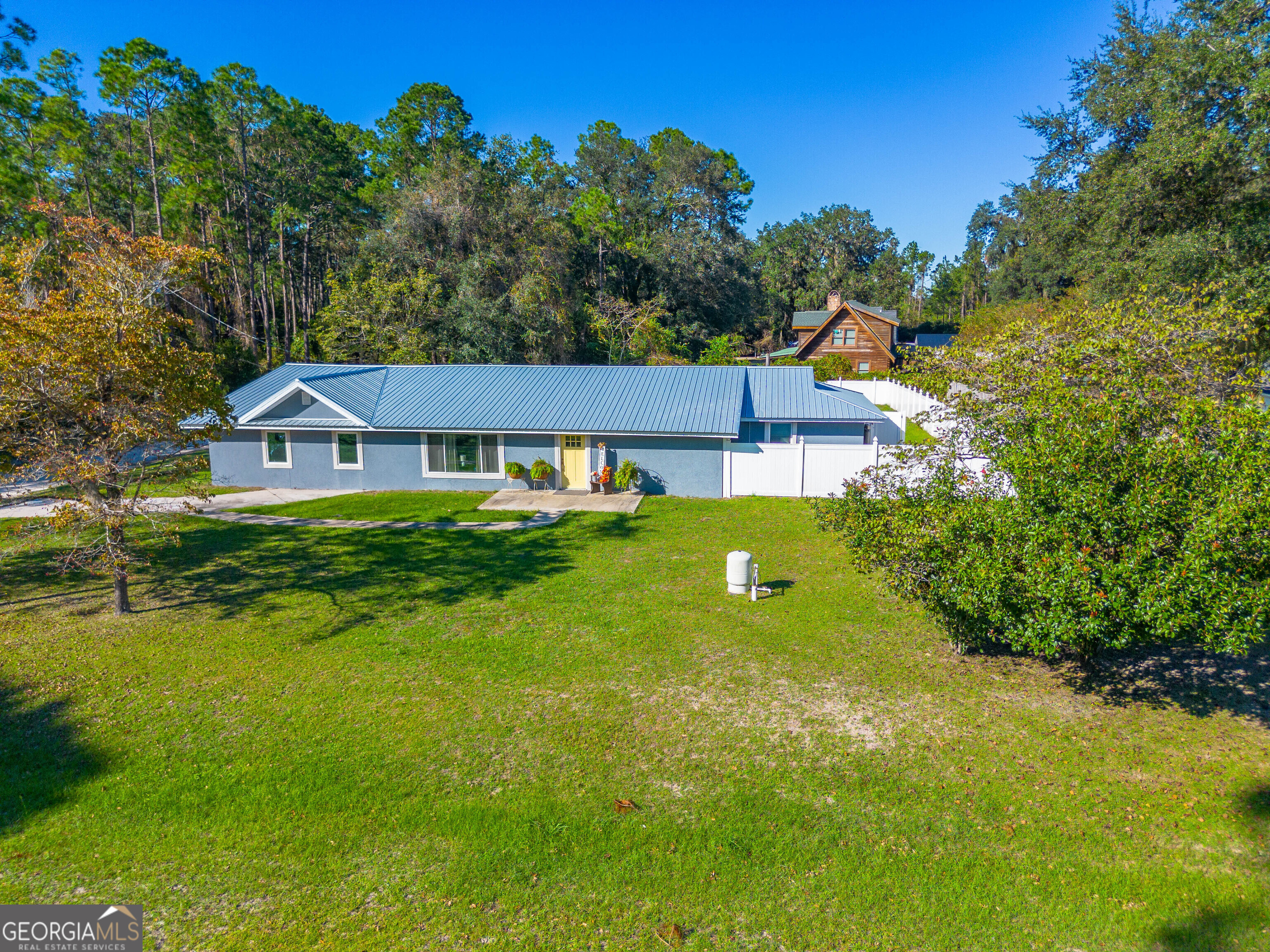 a aerial view of a house with swimming pool garden and patio