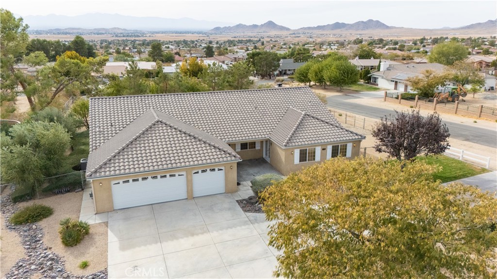 an aerial view of a house with a yard and plants