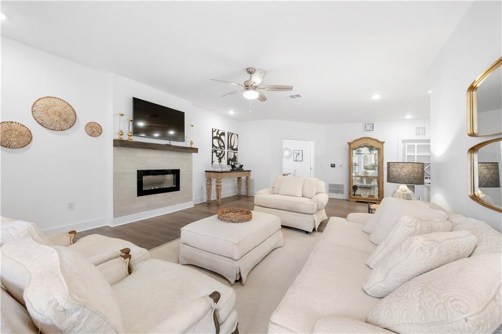 a living room with furniture a fireplace and a flat screen tv