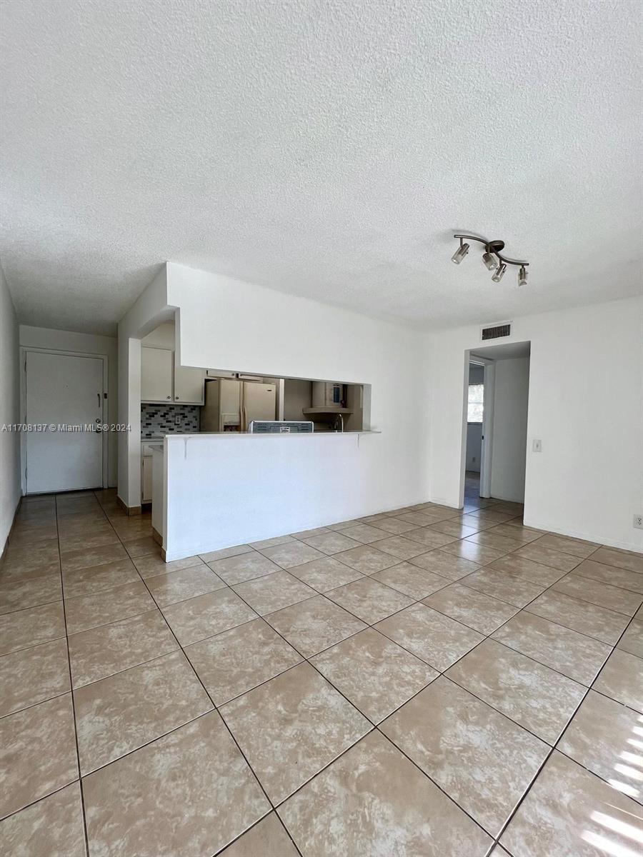 a view of a kitchen with a sink and cabinets