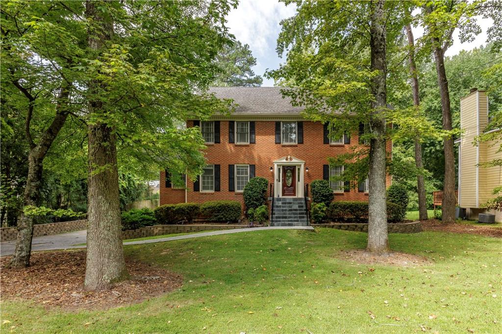 a front view of a house with a yard