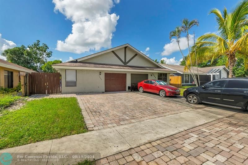 a car parked in front of house with a yard