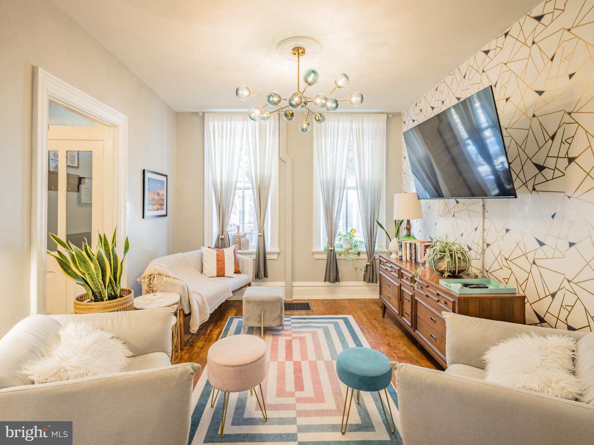 a living room with furniture and a chandelier