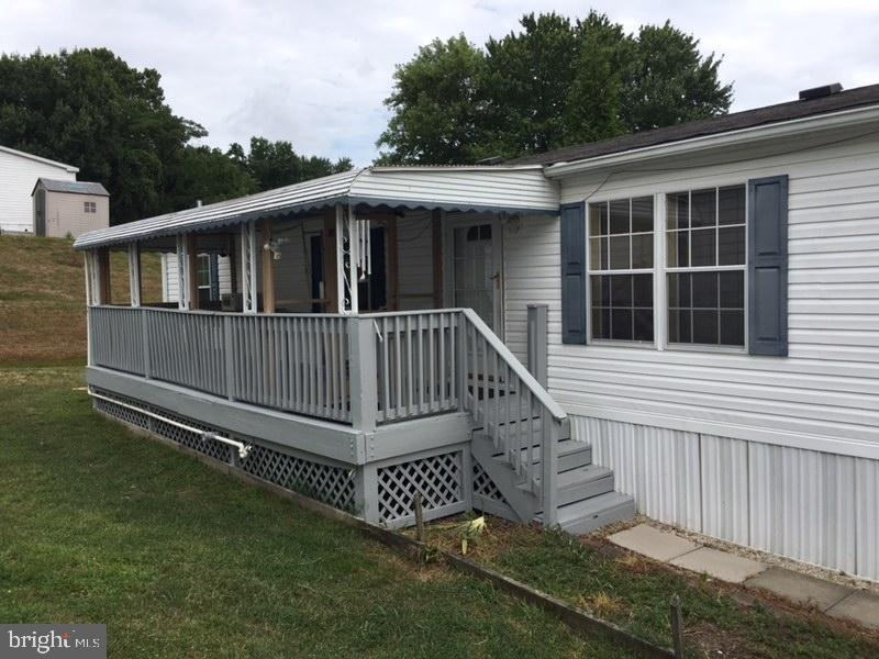 a view of a house with a yard and deck