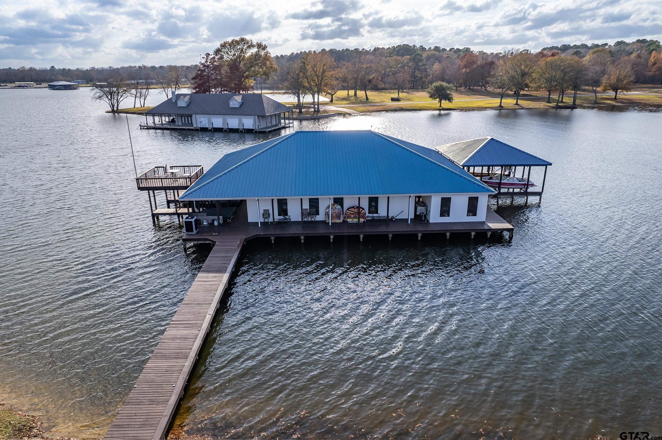 a aerial view of a house with wooden floor and lake view