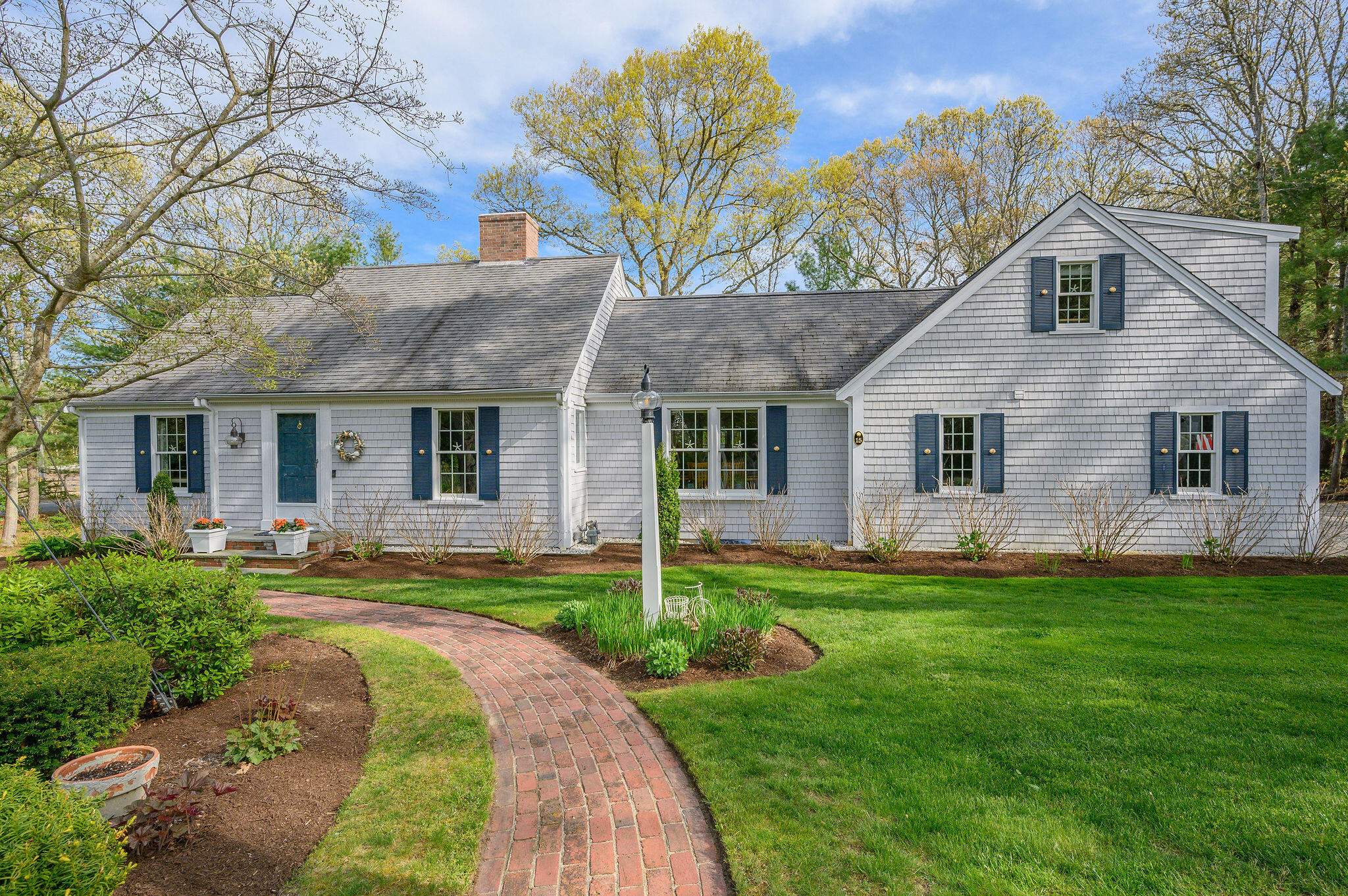 a front view of a house with a yard and porch