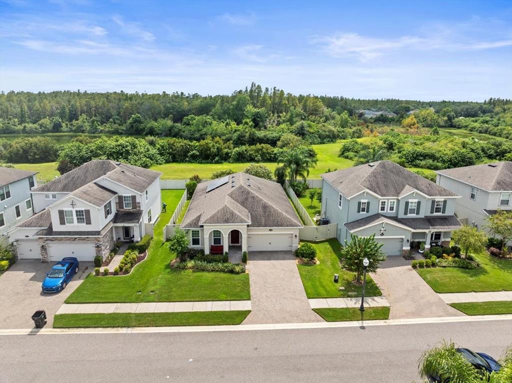 an aerial view of multiple houses with a yard