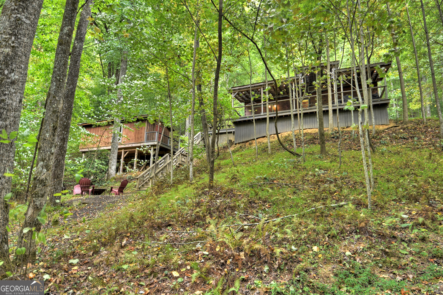 a view of yard with swimming pool and trees in the background