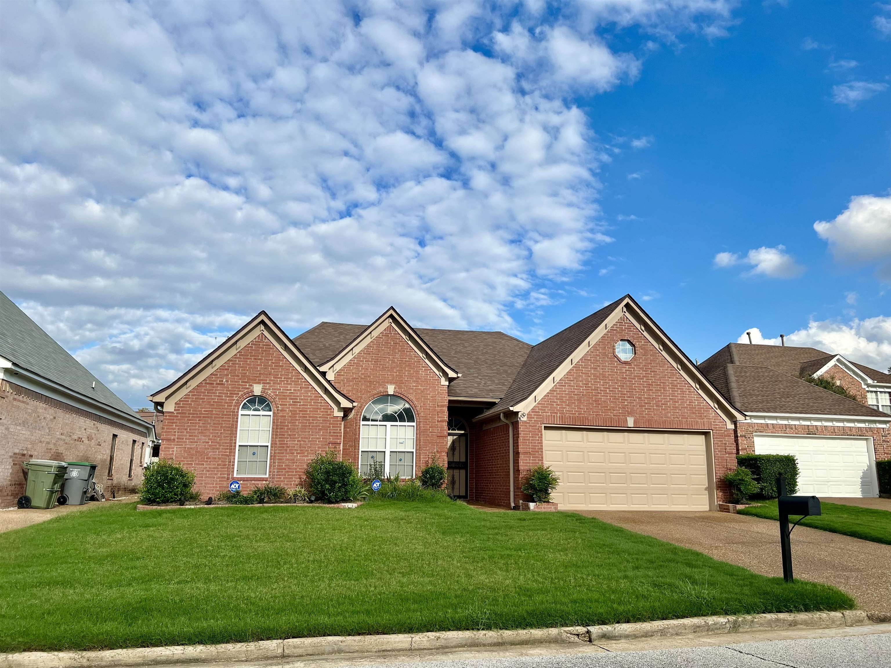 View of front of home with a front lawn and a garage