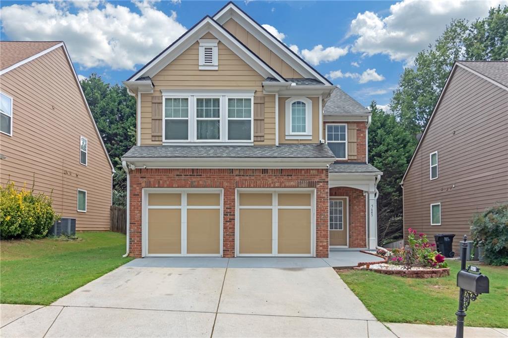 a front view of a house with a yard and garage