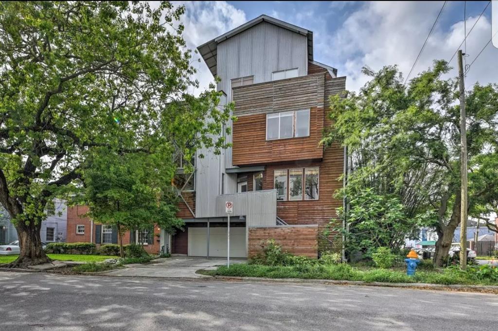 a tall brick building with a tree in front of it