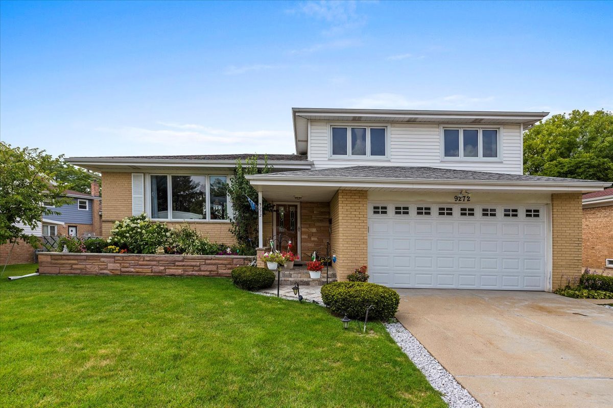 a front view of house with yard and green space