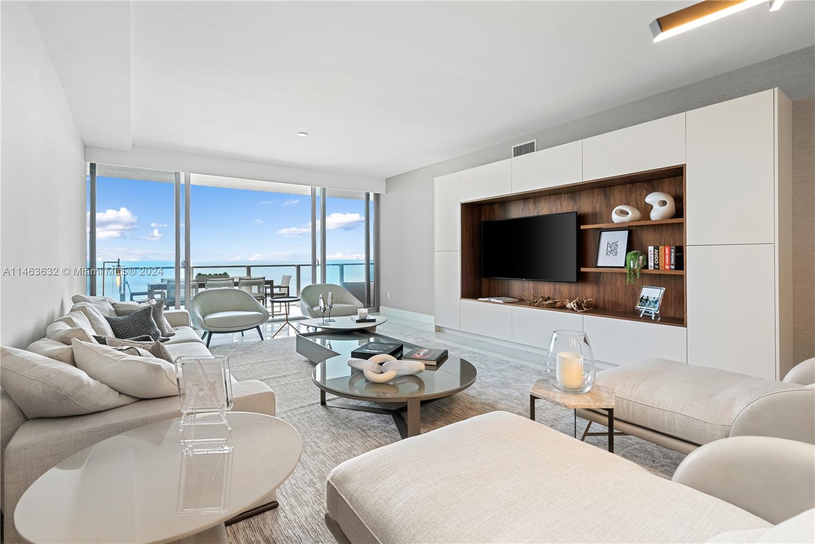 a living room with furniture kitchen view and a flat screen tv