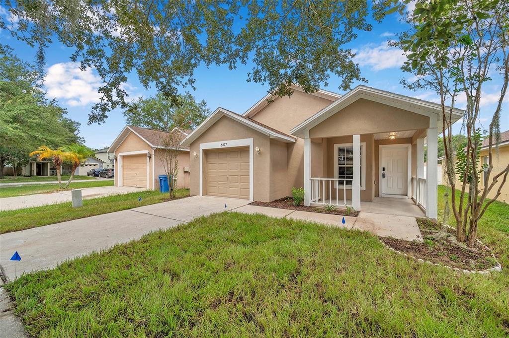 a front view of a house with a yard and garage