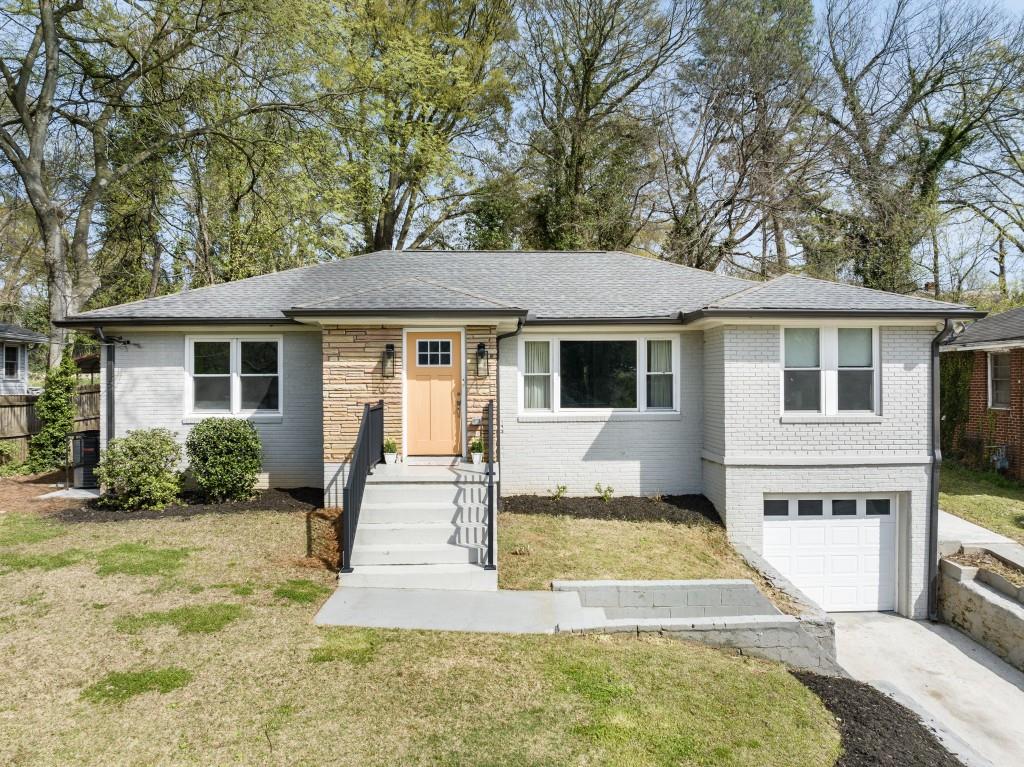 a view of a house with backyard and sitting area