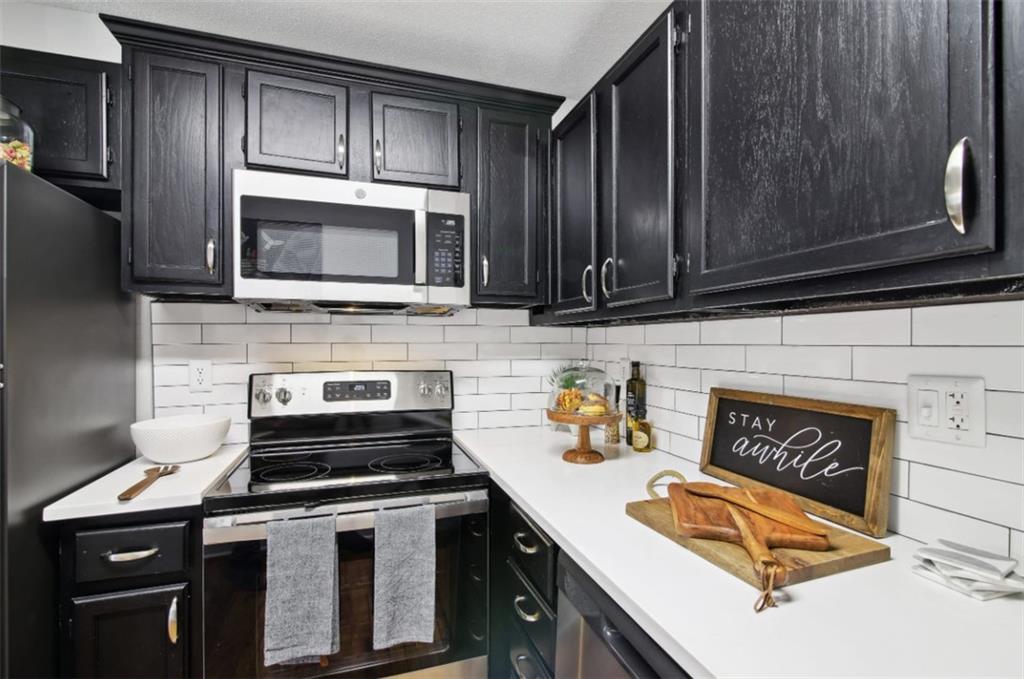 a kitchen with a stove microwave and sink