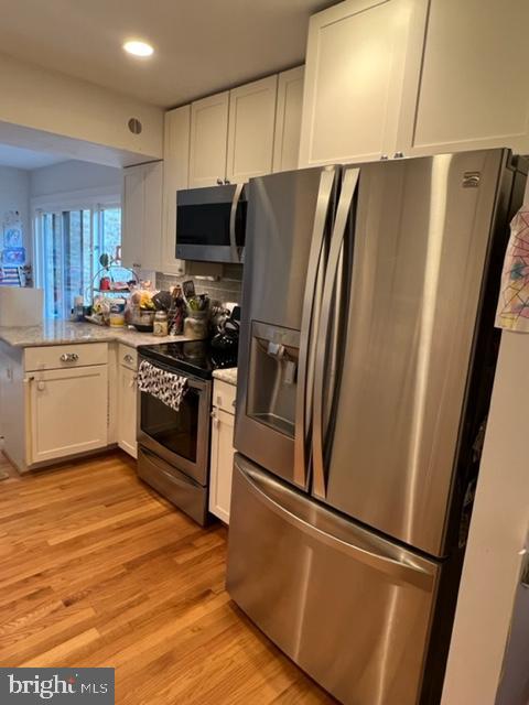 a kitchen with stainless steel appliances a refrigerator sink and microwave