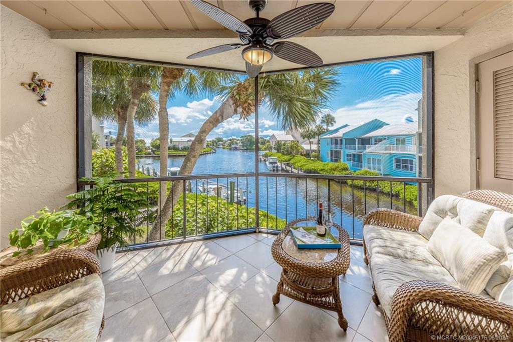 a view of a porch with furniture and a yard