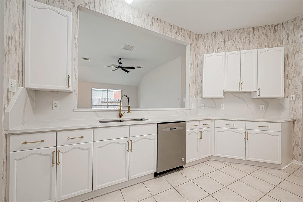 a kitchen with white cabinets and white appliances