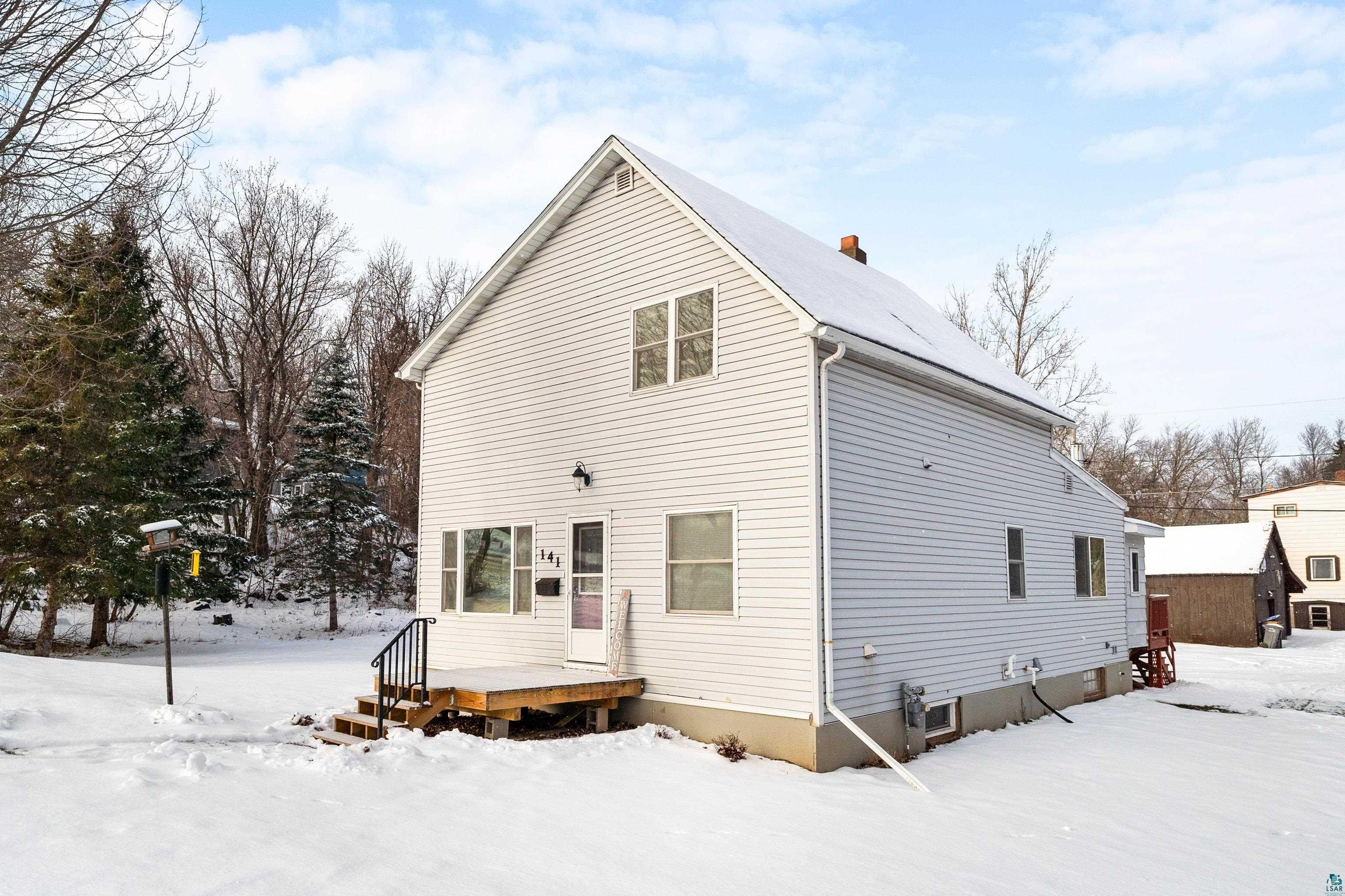 View of snow covered rear of property