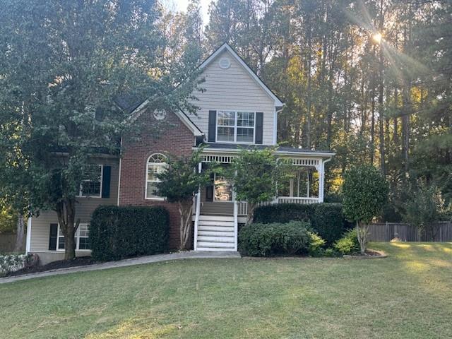 a front view of a house with a garden